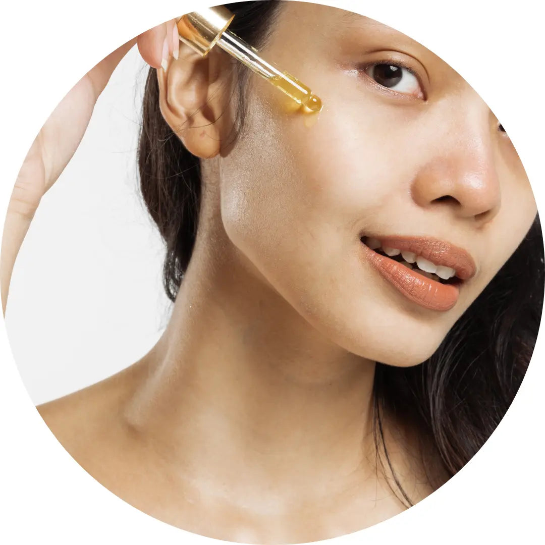 A Woman Applying Buddha Beauty Vegan Facial Oil