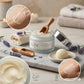 Cosmetic jar with lavender scent on a marble surface with lavender flowers and cream.
