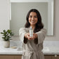 woman showing alchemy of skincare facial oil to the camera 