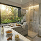 Modern bathroom with marble countertop, shower, and window view of greenery