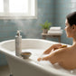 woman having a hot bath with alchemy massage oil
